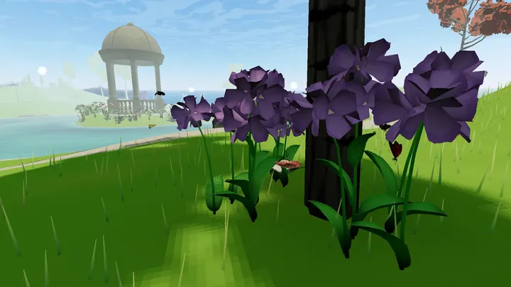 Purple flowers on a green hill with a gazebo in the distance
