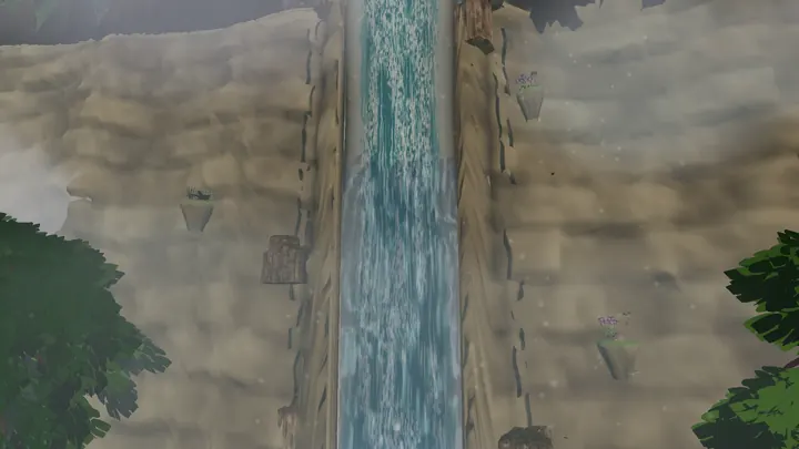 Looking down a tall waterfall between misty cliffs